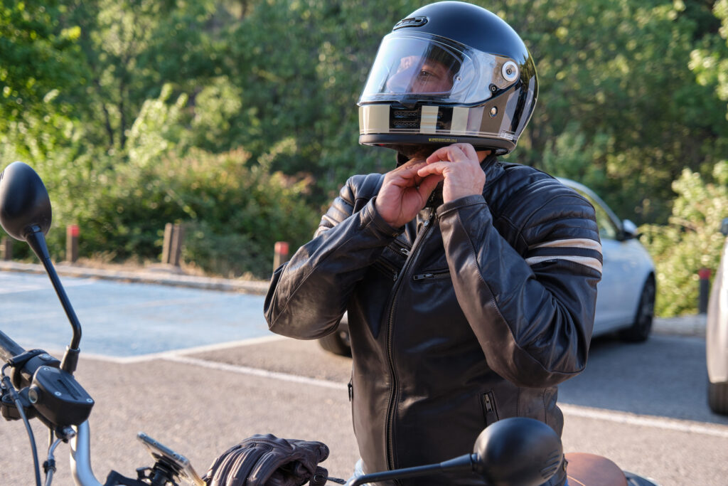 biker putting on motorcycle helmet california injury attorneys