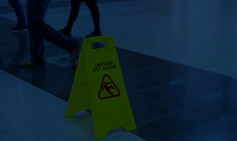 premises liability lawyers at Chain Cohn Clark, image of caution sign in blues