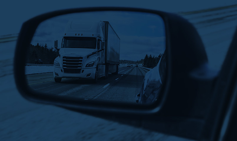 truck accident lawyer, truck crash attorney, image of truck in rear view mirror.