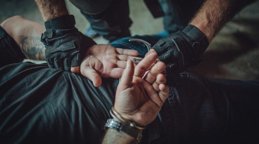 Police violence, Special police forces putting handcuffs on a man