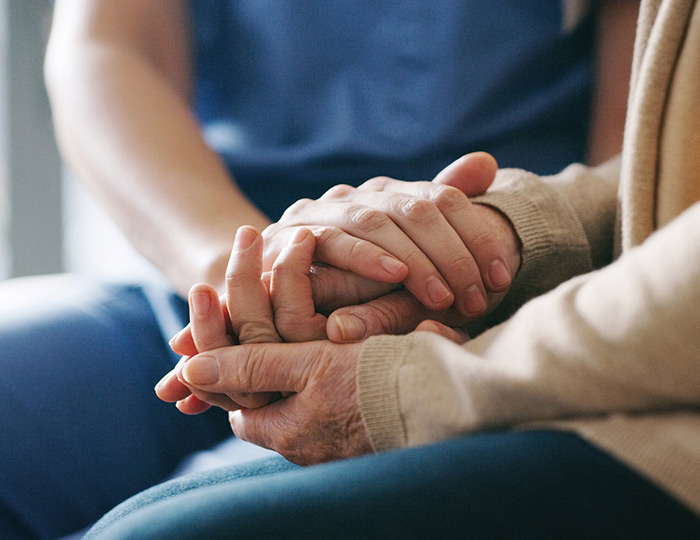 Hands holding comforting each other, to represent wrongful death lawsuits in Bakersfield